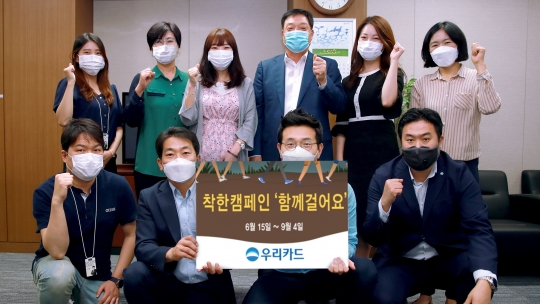 우리카드가 장애인들에게 휠체어를 지원하기 위해 진행하는 ‘함께 걸어요’ 캠페인 참여 임직원들이 기념촬영을 하고 있다. 사진=우리카드