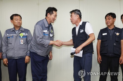 대우조선해양 하청 노사협상이 극적으로 타결된 22일 경남 거제시 대우조선해양 옥포조선소에서 협력사 대표인 권수오 녹산기업 대표(왼쪽 두번째)가 홍지욱 금속노조 부위원장(왼쪽 세번째)과 악수하고 있다. 사진=연합뉴스